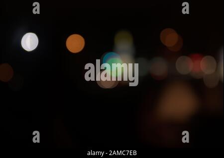 Multi-colored, blurry bokeh balls at night Stock Photo