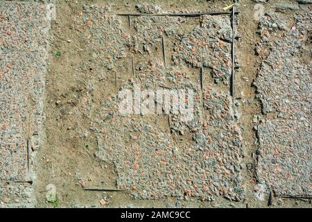Texture of damaged reinforced concrete floor. Cement urban sidewalk with rusty metallic reinforcement. Concrete texture Stock Photo