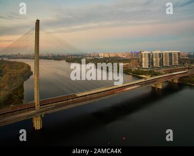 Traffic on a bridge. Modern metropolis with intersection of the traffic trails on a bridge. Traffic jams of roadside, transportation motion in a big Stock Photo