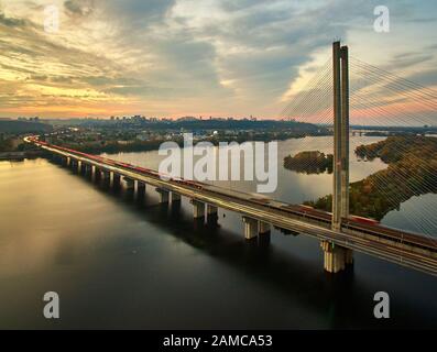 Traffic on a bridge. Modern metropolis with intersection of the traffic trails on a bridge. Traffic jams of roadside, transportation motion in a big Stock Photo