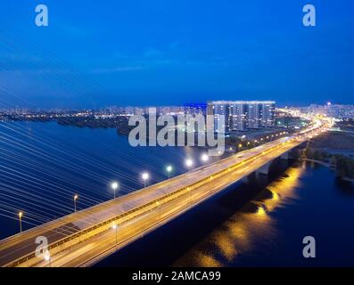 Traffic on a bridge. Modern metropolis with intersection of the traffic trails on a bridge. Traffic jams of roadside, transportation motion in a big Stock Photo