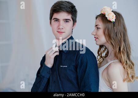 young beautiful woman leaned her forehead against back of head of man. Beautiful loving couple on Valentine's Day. boy thinks what gift to give for Ma Stock Photo