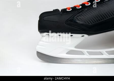 Hockey skates front with blade closeup isolated on grey background. Selective focus. Stock Photo