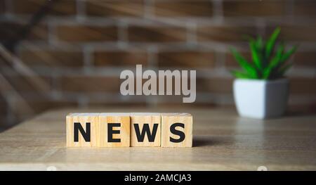 Jumbled wooden letter tiles spelling out the word News Stock Photo