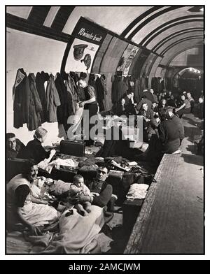WW2 Underground Tube Shelter World War II Blitz Bombing WW2 Londoners camp out for the night at the tube underground station along the platform and train tracks during heavy bombing by the Germans in London, England, 1940 in World War II. Families fled their homes at the sound of the air raid sirens, and remained here until the all-clear signal. Stock Photo