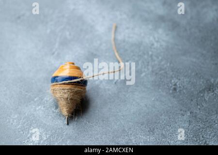 Classic wooden spinning top toy with string Stock Photo