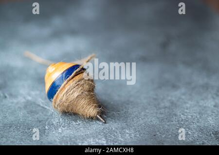 Classic wooden spinning top toy with string Stock Photo