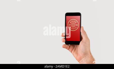 Hand holding smart phone with digital red packet for Chinese new year displayed on the screen -  holidays celebrations and technology concept. Stock Photo