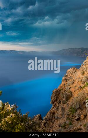 Crater Lake Highlighted Bright Blue Before Storm in Summer Stock Photo