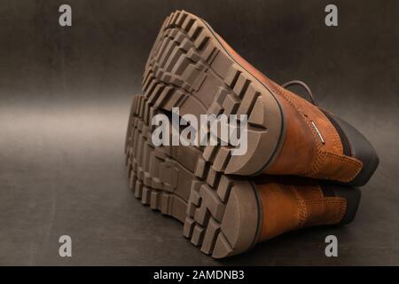Brand new brown winter boots on gray background