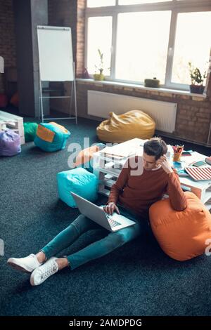 Top view of freelancer feeling thoughtful while having complicated task Stock Photo