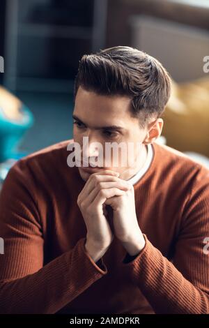 Handsome man feeling thoughtful while having too much work Stock Photo