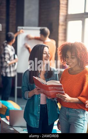 Two best friends enjoying their time while studying Chinese together Stock Photo