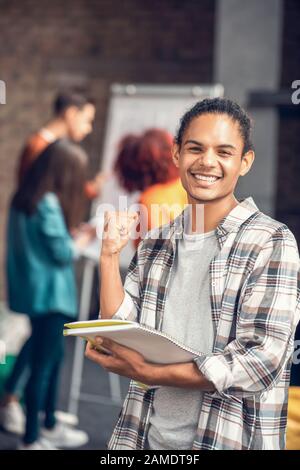 Cheerful student feeling happy while studying with friends Stock Photo