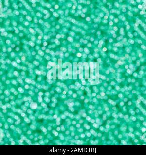 Abstract green light bokeh. Defocused background. Seamless square texture. Stock Photo
