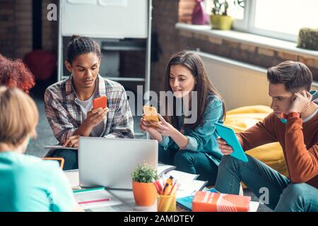 Students using gadgets while searching for information Stock Photo