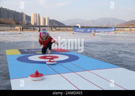 Beijing, China. 12th Jan, 2020. A child plays curling on a frozen lake in Mentougou District of Beijing, capital of China, Jan. 12, 2020. Credit: Hou Jiqing/Xinhua/Alamy Live News Stock Photo