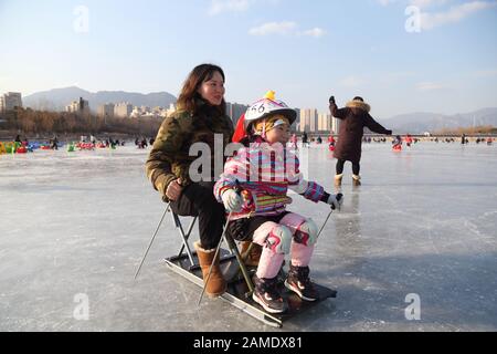 Beijing, China. 12th Jan, 2020. People have fun on a frozen lake in Mentougou District of Beijing, capital of China, Jan. 12, 2020. Credit: Hou Jiqing/Xinhua/Alamy Live News Stock Photo