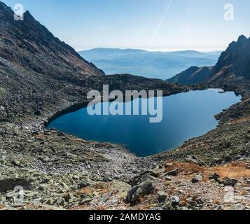 Vysne Wahlenbergovo pleso lake in Vysoke Tatry mountains with Nizke Tatry mountain range on the background in Slovakia Stock Photo