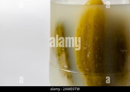 Closeup of tasty cucumbers in a glass jar. Selective focus. Landscape photo arrangement. Stock Photo