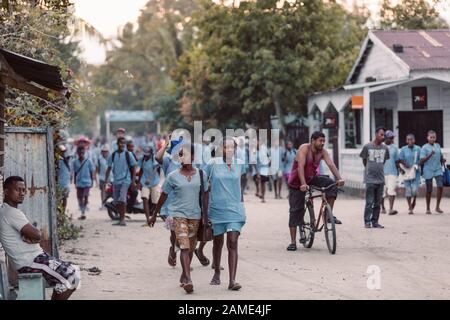 MAROANTSETRA, MADAGASCAR OCTOBER 19.2016: Malagasy students dressed in school uniforms in the evening on Maroantsetra street. October 19. 2016, Madaga Stock Photo