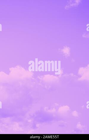 Pale violet background. Beautiful fluffy clouds on a sky background. Copy space. Purple violet toned Stock Photo