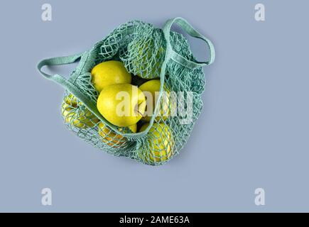 Bag with apples on a gray background. Caring for the environment and rejection of plastic. Flat lay. Stock Photo