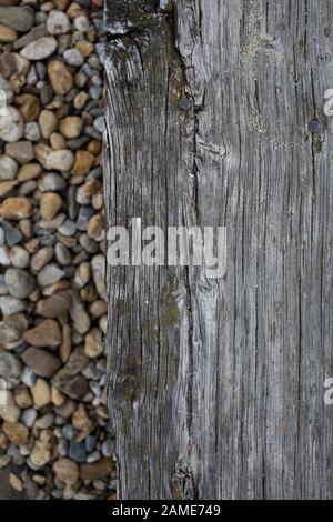 old board and stones on the beach Stock Photo