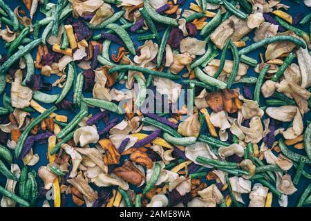 Healthy vegan snacks. Vegetable crisps on slate pattern Stock Photo