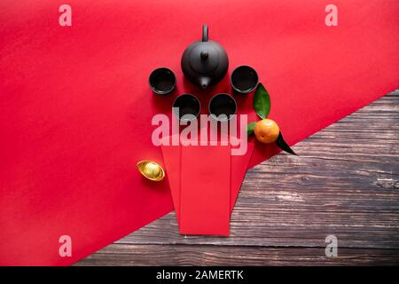 Chinese New Year offering red envelope and Chinese tea pot, Translation of text appear in image: Prosperity, rich and healthy Stock Photo