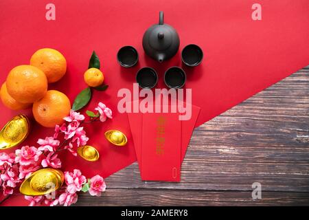 Chinese New Year offering red envelope chinese tea pot and orange , Translation of text appear in image: Happy New Year, Prosperity, rich and healthy Stock Photo