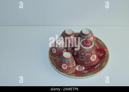 Vintage China porcelain tea set consists of teapot, four cups and a saucer with chinese style decoration, the characters on tea set mean longevity Stock Photo