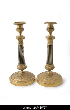 Candlesticks paar of the 19th century. (1830). France. Bronze with gilding. Path on white background. Stock Photo