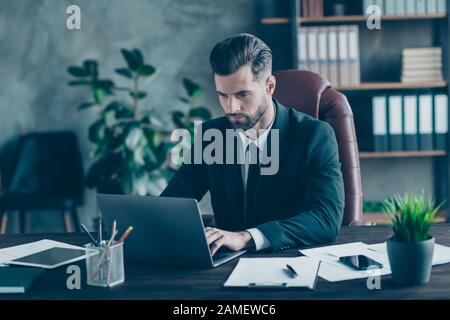 Photo of handsome business guy notebook table chatting with colleagues partners seriously reading corporate report wear black blazer white shirt suit Stock Photo