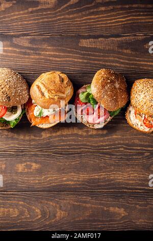 Assorted sandwiches on wooden table Stock Photo