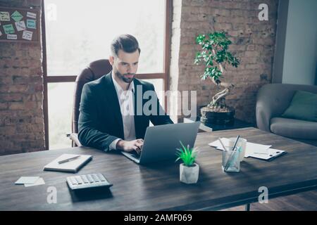 Photo of handsome business guy notebook table chatting with colleagues partners seriously reading corporate report wear black blazer white shirt suit Stock Photo