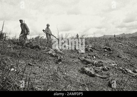 US Marines inspect the bodies of Japanese soldiers after an unsuccessful banzai attack on one of the hills in the Battle of Guam. The island of Guam w Stock Photo