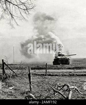 Burning M4A1 (76) W “Sherman” medium tank from the 3rd US tank division, destroyed by German artillery in Bergerhausen, Kerpen, Germany. March 01, 194 Stock Photo