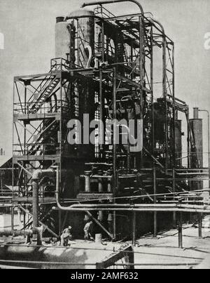 The life in Soviet Union in 1930s. From soviet propaganda book. Photo: Mounting the soviet tubular in Baku. The young oil machine-building industries Stock Photo