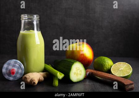 Homemade smoothie with the following detox ingredients ginger, cucumber, apple and lemon. Stock Photo