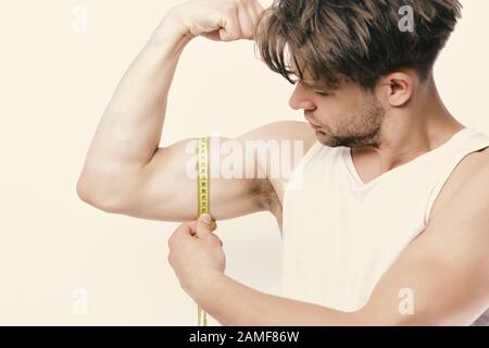 https://l450v.alamy.com/450v/2amf86w/man-with-long-yellow-measuring-tape-around-muscle-guy-with-attentive-face-isolated-on-white-background-measurement-and-sports-lifestyle-concept-athlete-with-messy-hair-showing-biceps-and-triceps-2amf86w.jpg