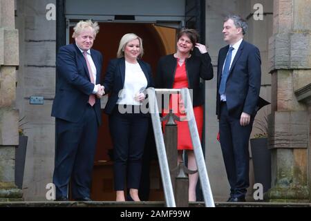 Belfast, Northern Ireland. 13th Jan 2020. British Prime Minister Boris Johnston (left) and Secretary of State for Northern Ireland Julian Smith (right) is greeted by the new Deputy First Minister Michelle O'Neill and First Minister Arlene Foster at Stormont Castle, Belfast, Northern Ireland on Jan 13, 2020. Prime Minister Boris Johnson has arrived at Stormont to mark the restoration of devolution in Northern Ireland. Taoiseach (Irish prime minister) Leo Varadkar is due later on Monday. Credit: Irish Eye/Alamy Live News Stock Photo