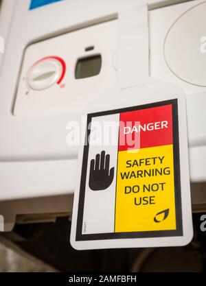 Gas safety warning sign on a faulty broken gas boiler Stock Photo