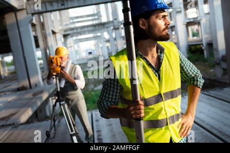 Team of construction engineers, architects working on building site Stock Photo