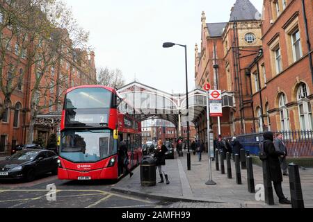 Passenger boarding number 2 West Norwood double decker red bus  and people standing outside Marylebone train station in London NW1 UK   KATHY DEWITT Stock Photo