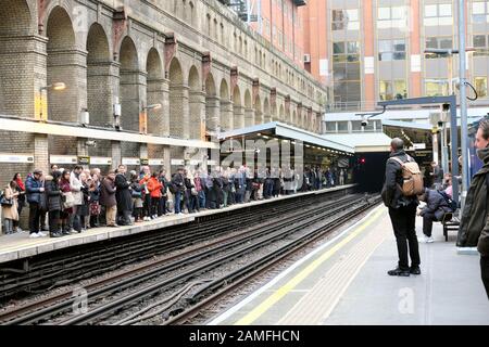 Barbican Station underground tube station train stations and passengers commuters waiting on the platform in London EC1 England UK  KATHY DEWITT Stock Photo