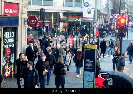 People pedestrians crossing the road at traffic lights at the junction of Holborn and Kingsway streets in London WC2 England UK  KATHY DEWITT Stock Photo