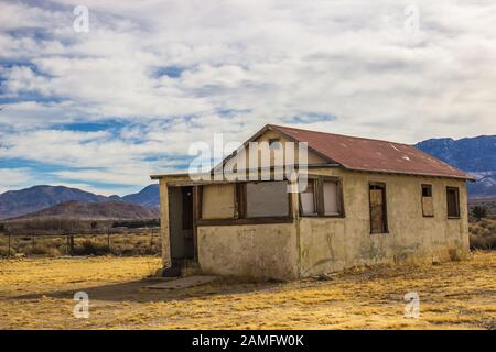 Boarded Up Windows On Abandoned Home In High Desert Stock Photo