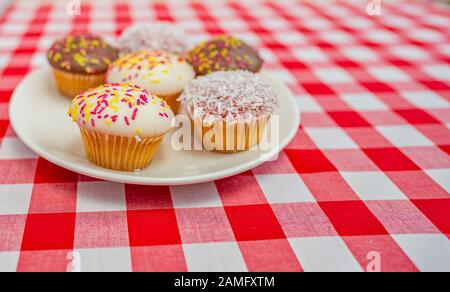 An English cake in a baking dish on a wooden board and a white wooden  table. Selective focus Stock Photo - Alamy