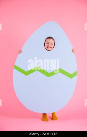 Happy child holding a huge easter eggs Stock Photo